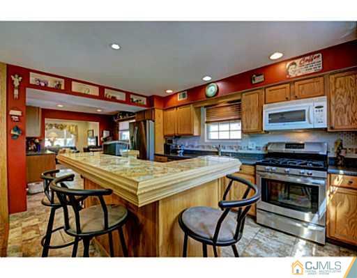 20 Kimberly Road Colonia, NJ 07067 - Photo 10 of 25 a kitchen with stainless steel appliances granite countertop a stove a sink and a microwave