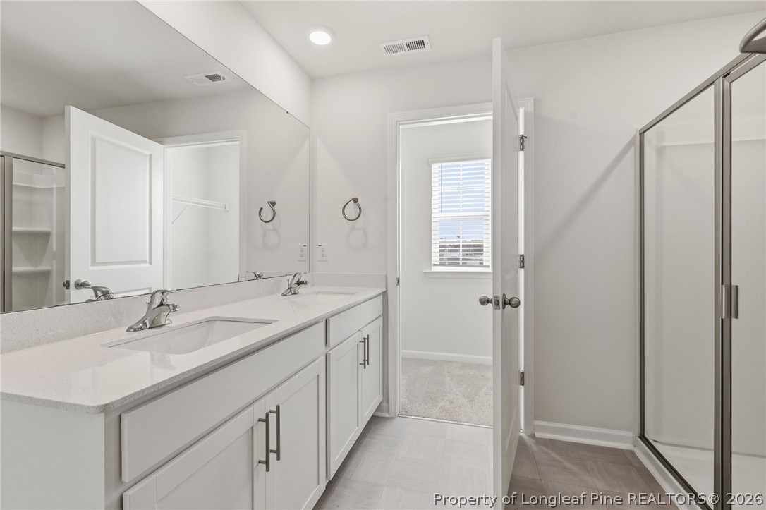 2208 Clydesmill Road Fayetteville, NC 28314 - Photo 21 of 26 a bathroom with a double vanity sink and mirror