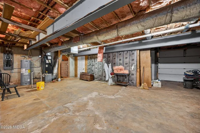 a utility room with dryer washer and a flat screen tv