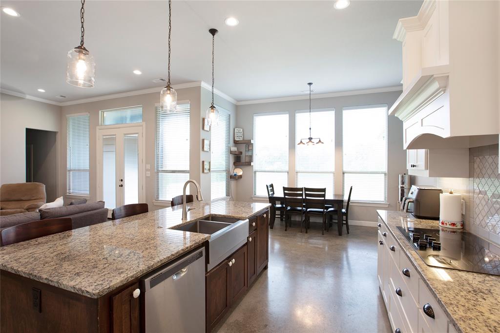 7230 Woodstream Road Midlothian, TX 76065 - Photo 11 of 26 a kitchen with sink refrigerator and large windows