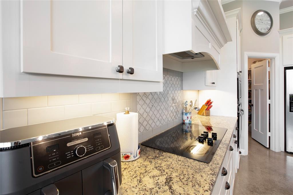 7230 Woodstream Road Midlothian, TX 76065 - Photo 12 of 26 a kitchen with a stove and a sink