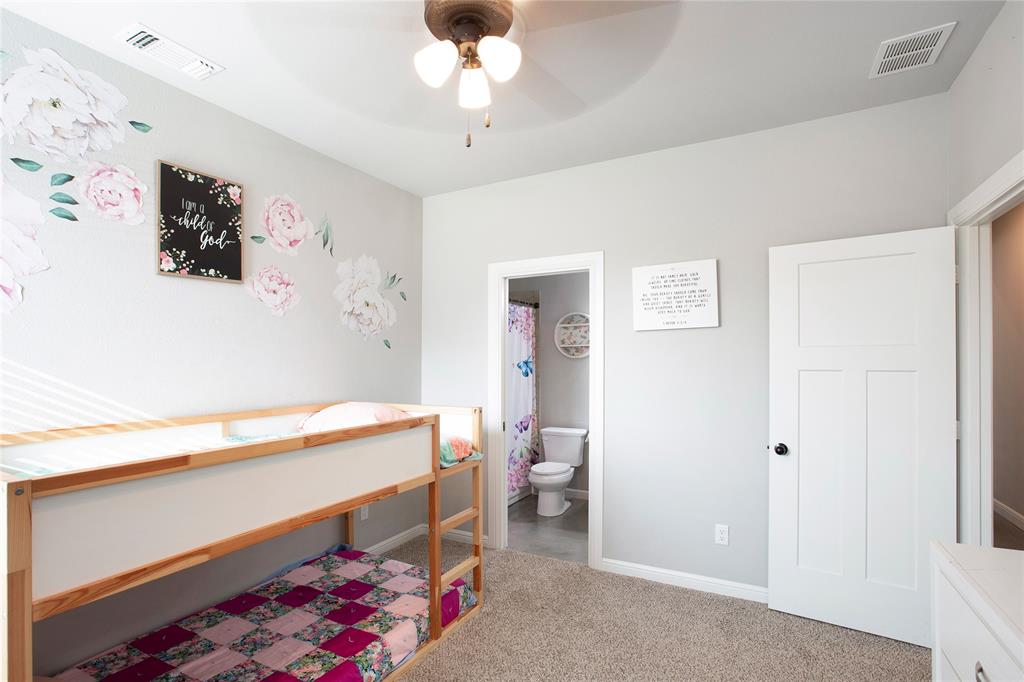 7230 Woodstream Road Midlothian, TX 76065 - Photo 20 of 26 a room with painting on the wall and a dresser