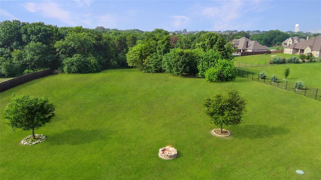 7230 Woodstream Road Midlothian, TX 76065 - Photo 5 of 26 a view of a garden with a building in the background