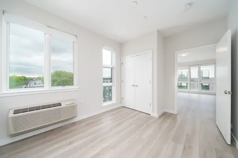 a view of a livingroom with wooden floor and windows