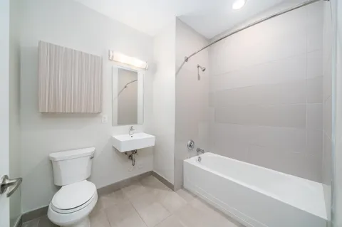 a bathroom with a toilet a sink and bathtub