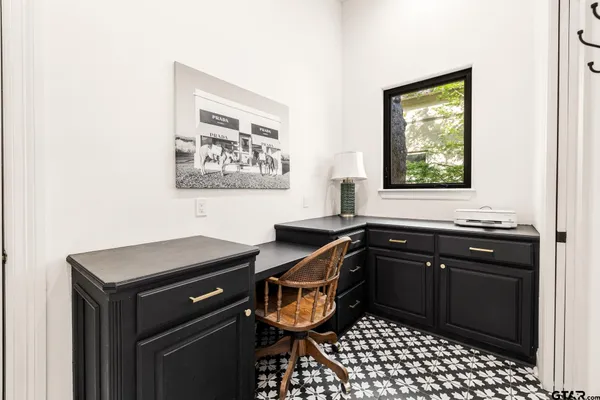 a bathroom with a black and white checkered floor