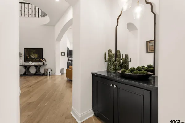 a kitchen with stainless steel appliances granite countertop a sink a stove and a wooden floors