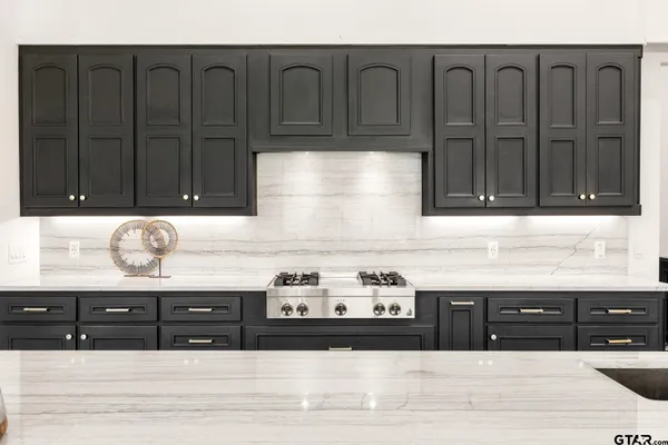 a kitchen with granite countertop a stove and a refrigerator