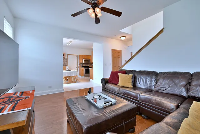 a living room with furniture and a wooden floor