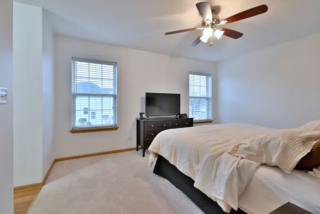 a bedroom with a large bed and a window