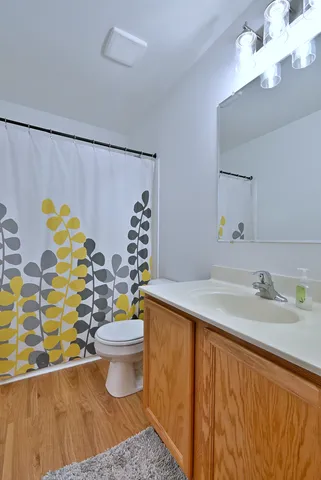 a bathroom with a sink toilet and shower