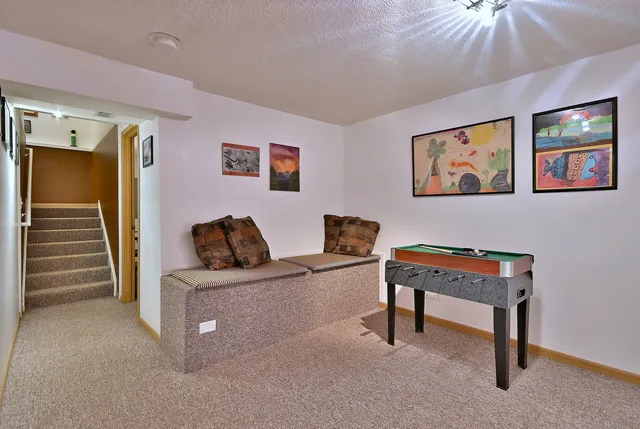 a living room with furniture and a piano