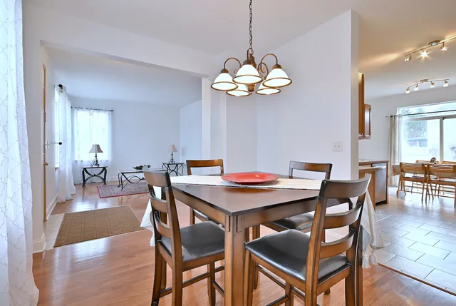 a view of a dining room with furniture wooden floor and chandelier