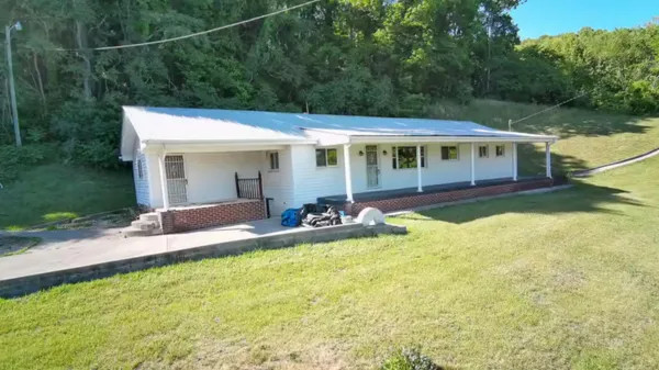 a view of a house with swimming pool and porch