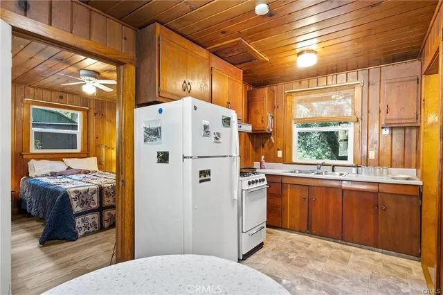 a kitchen with stainless steel appliances granite countertop a sink and a refrigerator