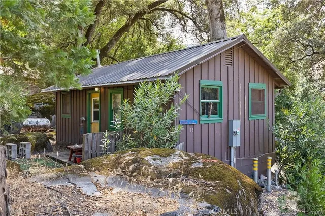 a view of a chair and table in backyard of the house