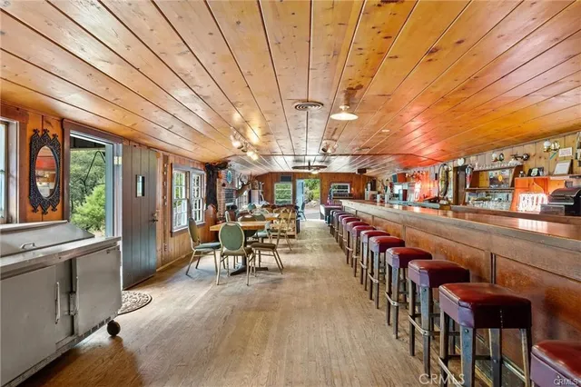 a room with pool table and windows