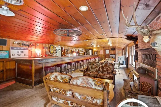 a view of a hallway with workspace and a window