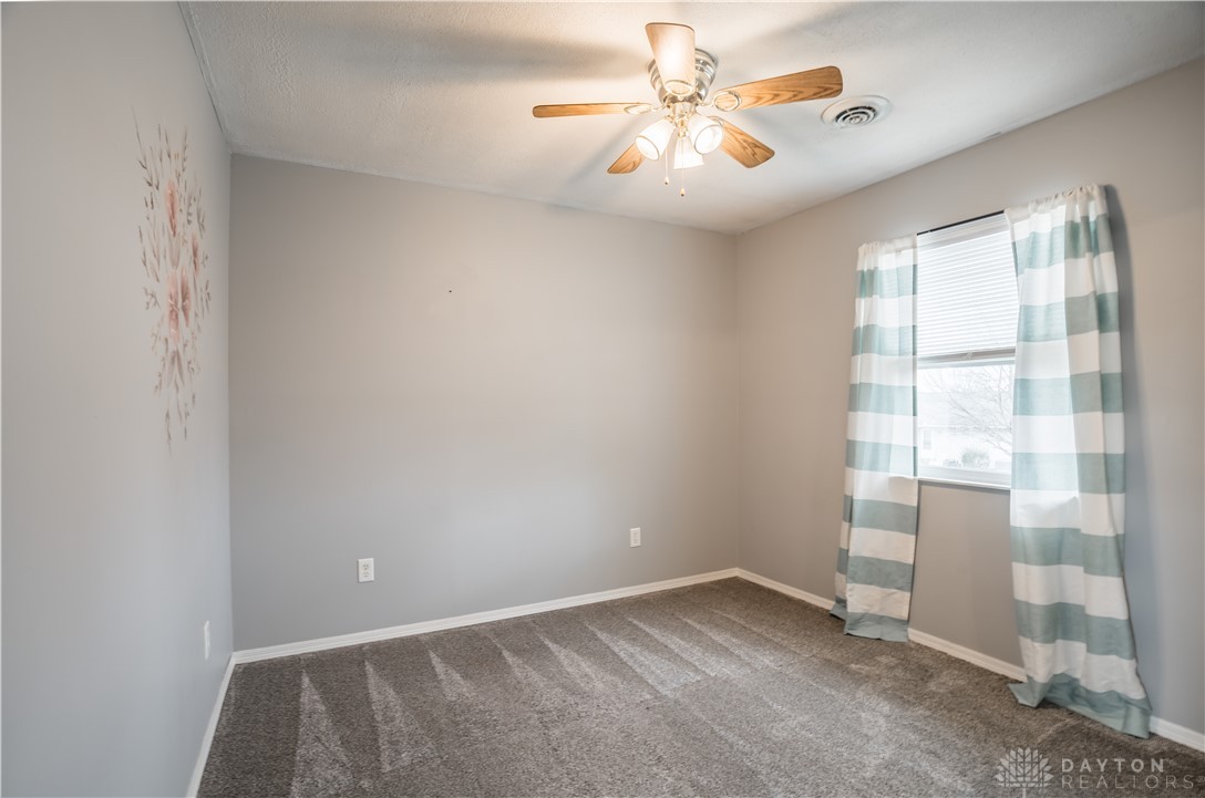1442 Langdon Road Sidney, OH 45365 - Photo 21 of 34 This serene bedroom offers a comfortable ambiance with its neutral tones and natural light.