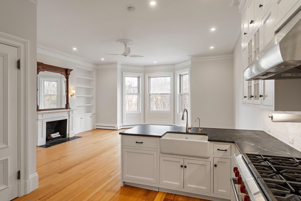 64 Commonwealth Avenue, Unit 5 Boston, MA 02116 - Photo 13 of 24 a kitchen with granite countertop a stove and a sink