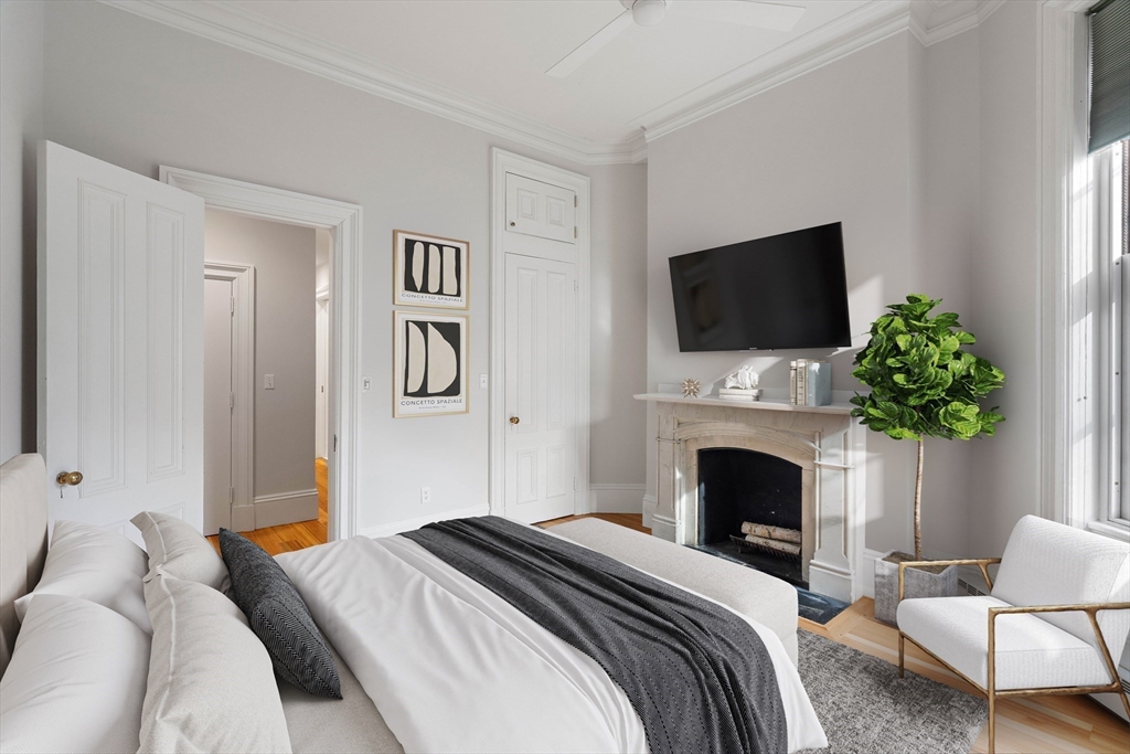 64 Commonwealth Avenue, Unit 5 Boston, MA 02116 - Photo 16 of 24 a bedroom with a bed and a fireplace