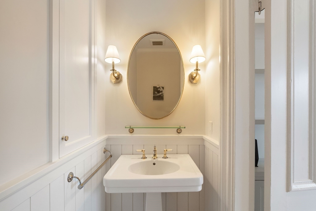 64 Commonwealth Avenue, Unit 5 Boston, MA 02116 - Photo 22 of 24 a bathroom with a sink and a mirror