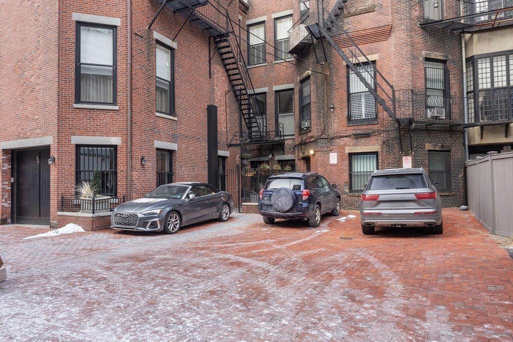 64 Commonwealth Avenue, Unit 5 Boston, MA 02116 - Photo 23 of 24 a car parked in front of a building