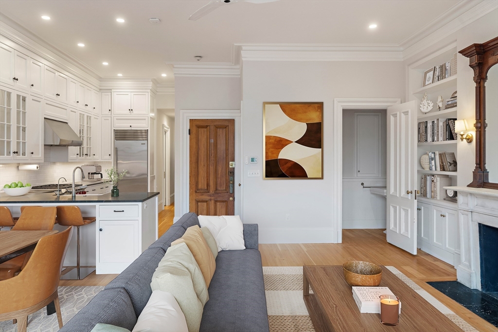 64 Commonwealth Avenue, Unit 5 Boston, MA 02116 - Photo 5 of 24 a living room with stainless steel appliances kitchen island granite countertop furniture and a kitchen view