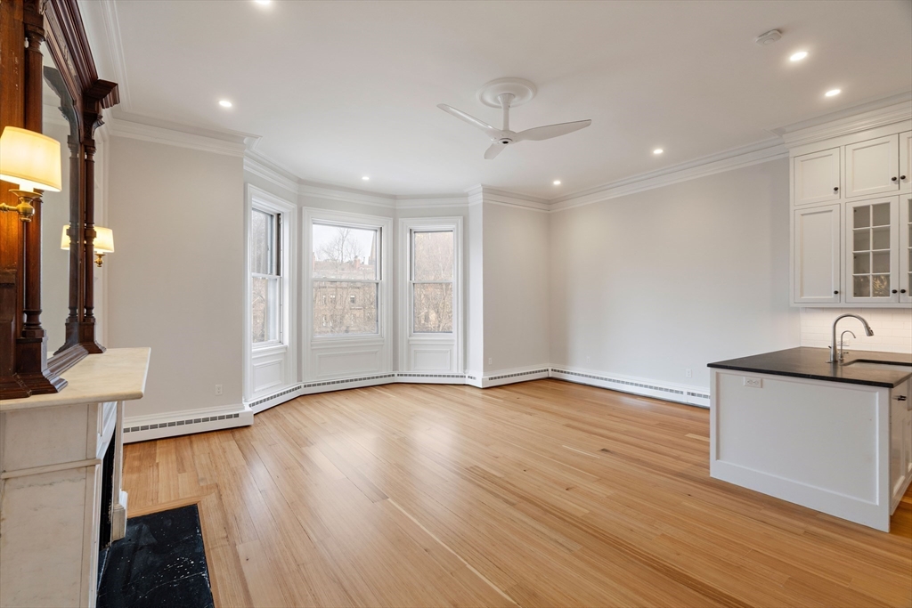 64 Commonwealth Avenue, Unit 5 Boston, MA 02116 - Photo 6 of 24 a view of an empty room with wooden floor and a window