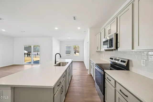 a kitchen with counter top space cabinets and stainless steel appliances