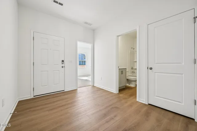 a view of an empty room and wooden floor