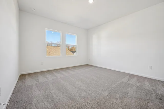 a view of an empty room with a closet