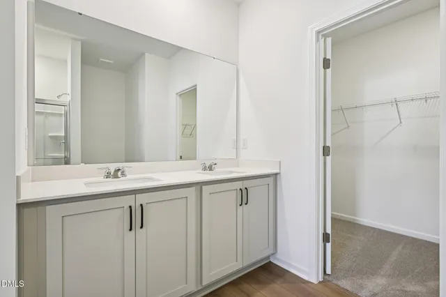 a bathroom with a double vanity sink and mirror