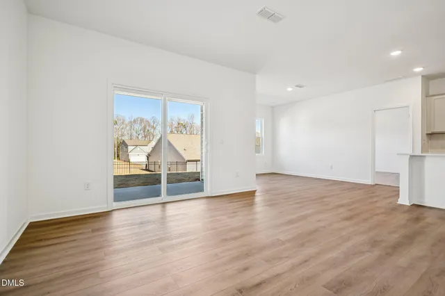a view of wooden floor and windows in a room