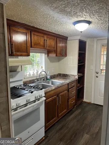 a kitchen with stainless steel appliances granite countertop a stove and a refrigerator