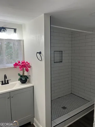 a bathroom with a shower and a sink
