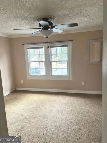 an empty room with a empty space and windows