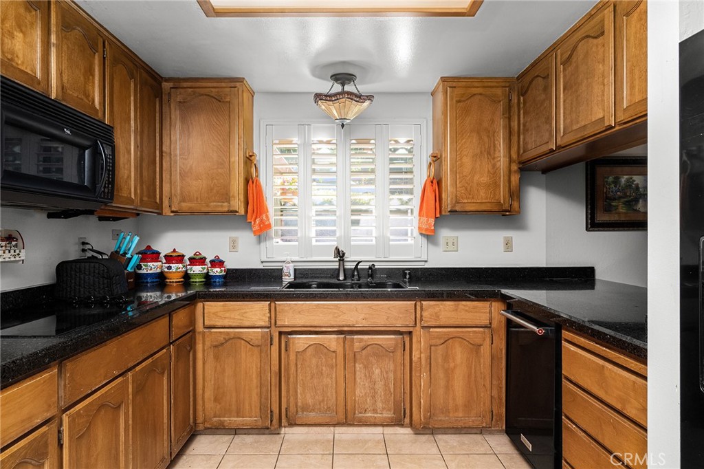 14219 Wycliff Way Magalia, CA 95954 - Photo 15 of 67 a kitchen with granite countertop a sink dishwasher stove and cabinets