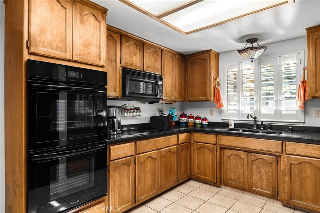 14219 Wycliff Way Magalia, CA 95954 - Photo 16 of 67 a kitchen with granite countertop cabinets stainless steel appliances a sink and a window