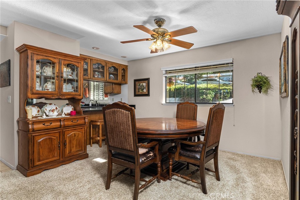 14219 Wycliff Way Magalia, CA 95954 - Photo 21 of 67 a dining room with furniture a window and a chandelier