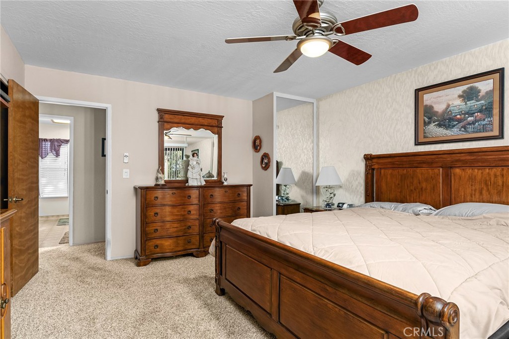 14219 Wycliff Way Magalia, CA 95954 - Photo 26 of 67 a room with a bed and a chandelier