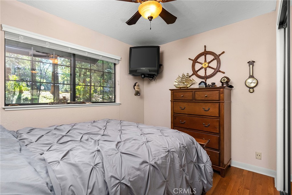 14219 Wycliff Way Magalia, CA 95954 - Photo 31 of 67 a bedroom with a bed and a chandelier