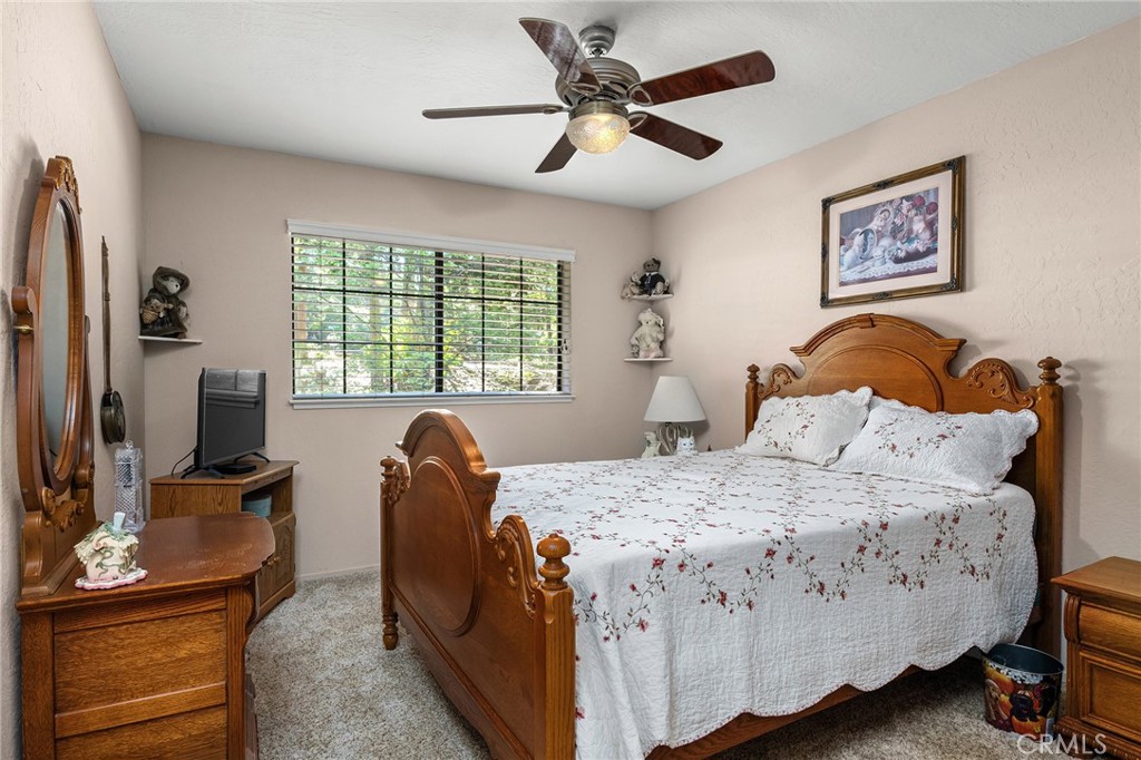 14219 Wycliff Way Magalia, CA 95954 - Photo 34 of 67 a bedroom with a bed and a flat tv screen on dresser