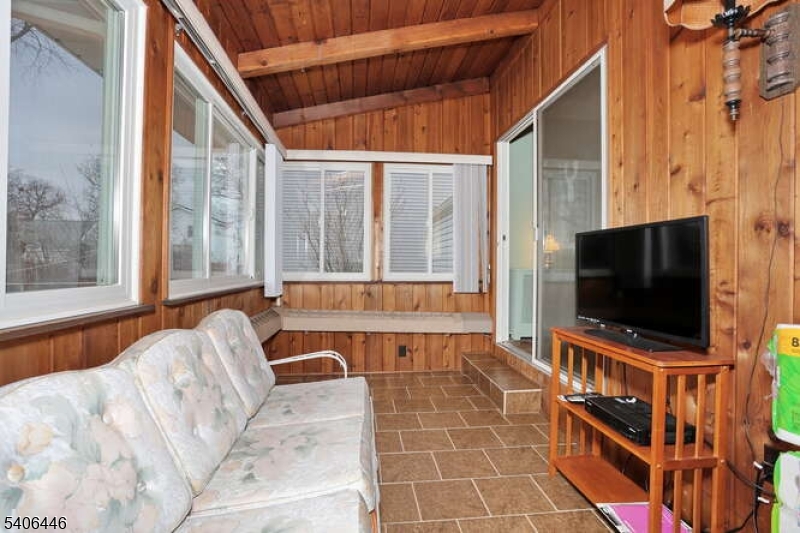 22-06 Arcadia Road Fair Lawn, NJ 07410 - Photo 13 of 33 a room with furniture and a flat screen tv