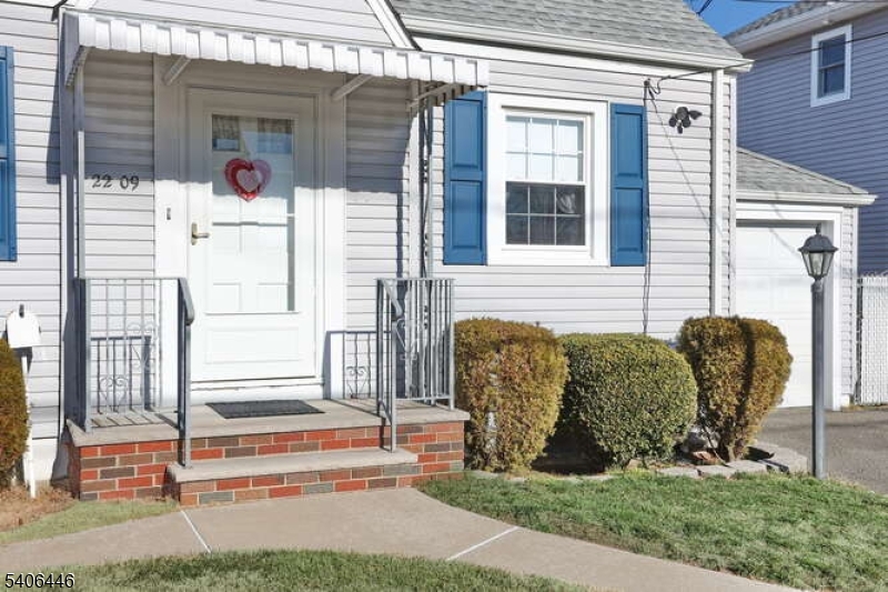 22-06 Arcadia Road Fair Lawn, NJ 07410 - Photo 2 of 33 a front view of a house with a porch