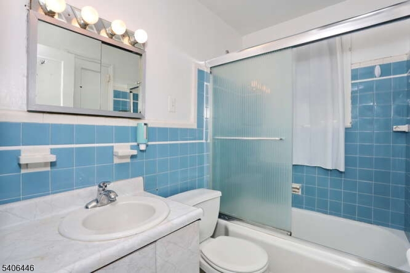 22-06 Arcadia Road Fair Lawn, NJ 07410 - Photo 9 of 33 a bathroom with a sink toilet and shower