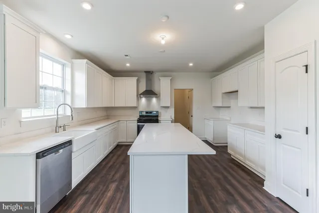 a kitchen with a sink stove and refrigerator