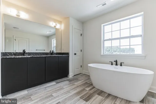 a bathroom with a bathtub and a sink
