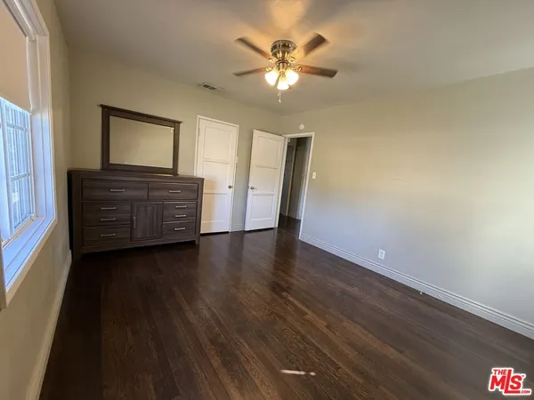 a view of room with window and wooden floor