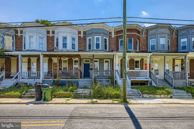 front view of a brick house with a yard